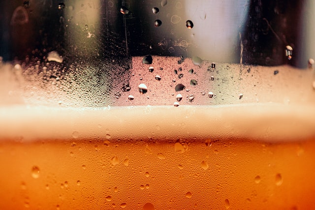 close-up of condensation, head of freshly poured beer in a glass