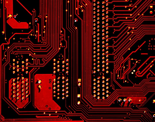 Microprocessors concept: close-up of motherboard, reverse detail (red tinted)